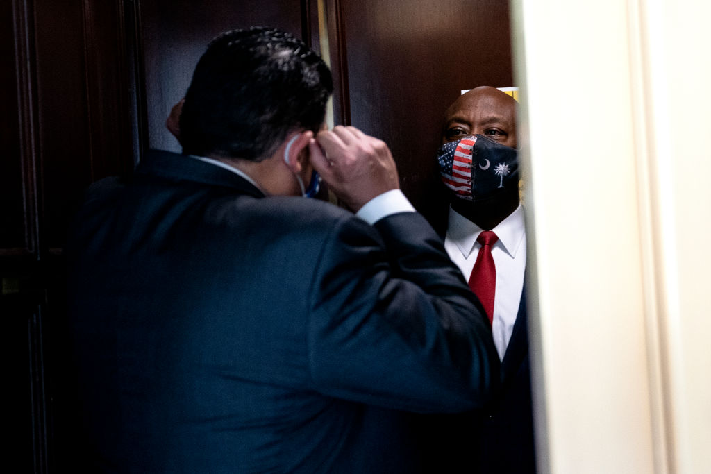 Sen. Tim Scott (R-S.C.), right, speaks to a reporter at the Russell Senate Office Building in Washington, D.C., on April 29. (Stefani Reynolds/Getty Images)