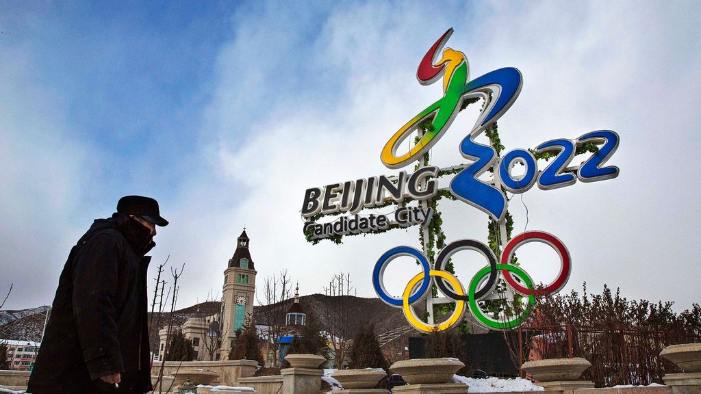 A Chinese man walks by a sign for the 2022 Olympics on January 22, 2016 in Chongli district, Hebei province, China. (Kevin Frayer/Getty Images)