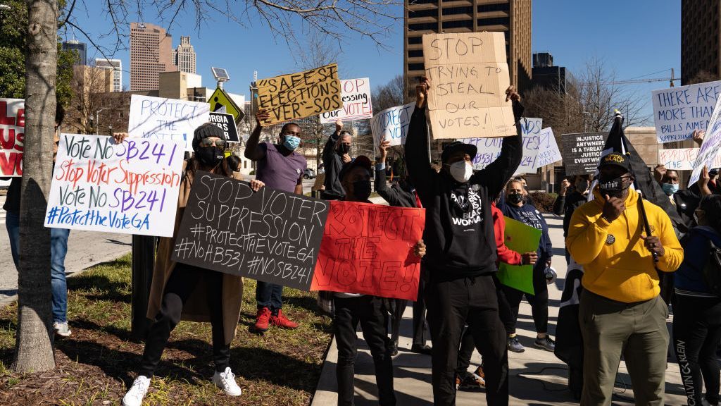 Demonstrators stand outside of the Georgia Capitol building to oppose the state's new voting laws. (Megan Varner/Getty Images)