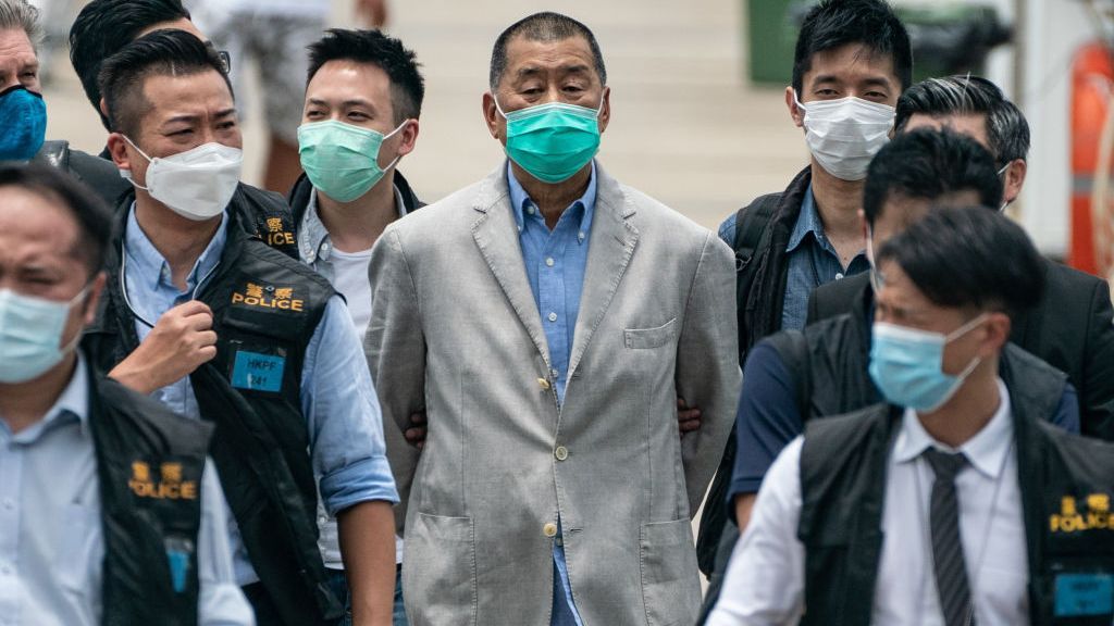 Hong Kong media tycoon and Apple Daily founder Jimmy Lai (C) is escorted by a group of police to the Royal Hong Kong Yacht Club Shelter Cove Clubhouse for evidence collection on August 11, 2020 in Hong Kong, China. Lai was arrested, along with several of his family members and associates, for alleged collusion with foreign forces under the new national security law. (Photo by Anthony Kwan/Getty Images)