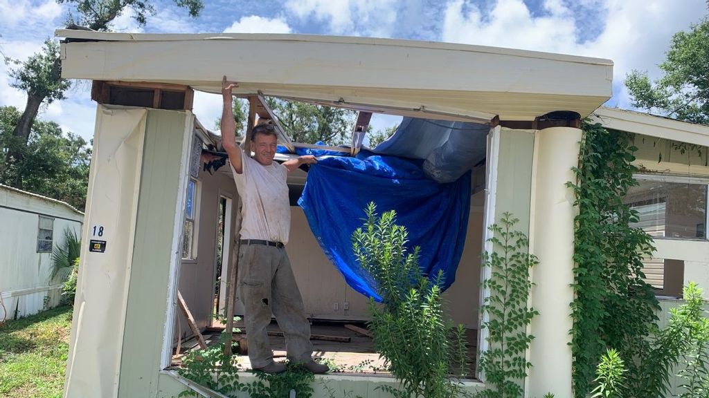 Richard Hogarth, a resident of a Pensacola trailer park, shows off the damage sustained by a home due to a recent hurricane. (Hamil Harris)